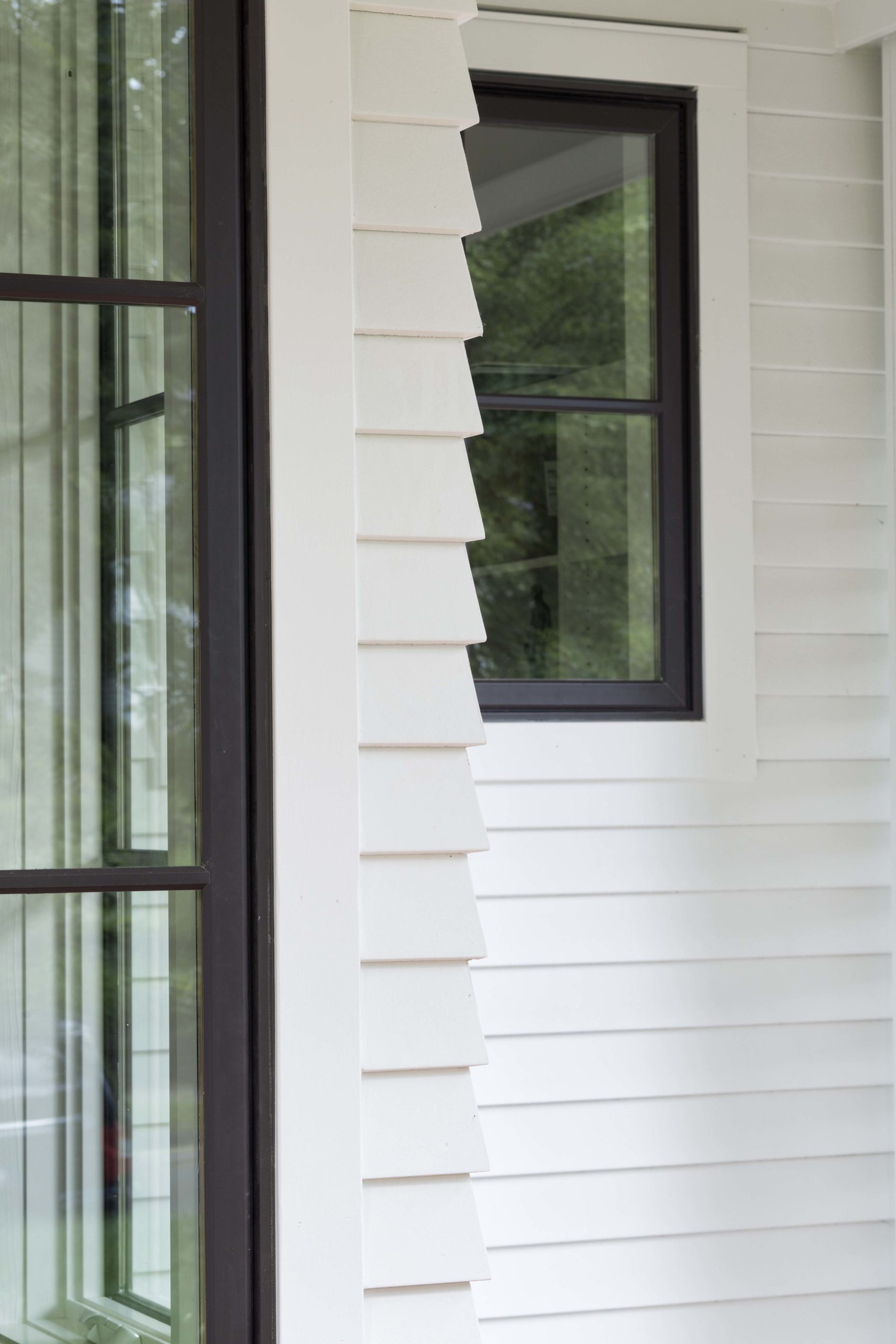 Close up of two windows on white home.
