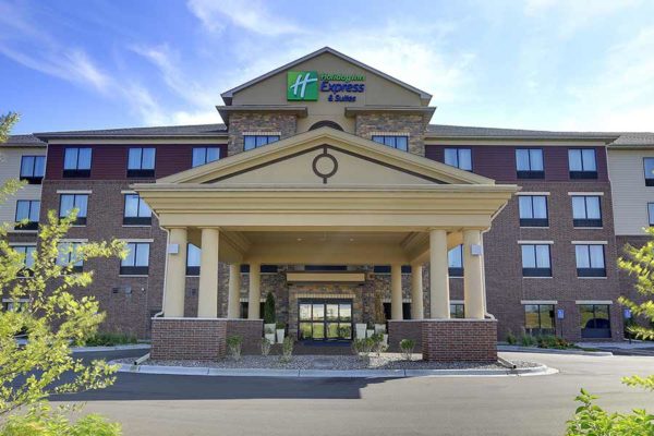 Front entry for a Holiday Inn Express and Suites, all brick with tan accent.