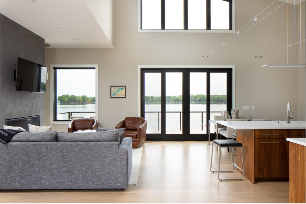Interior of modern living room and kitchen with twenty foot ceilings.