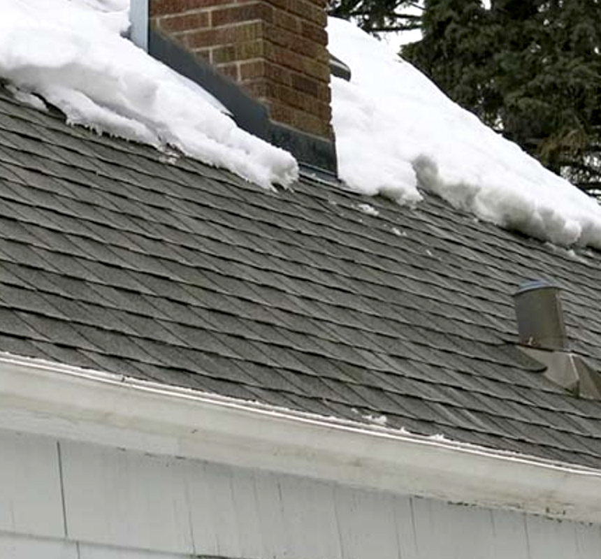 Close up of a home's roof line with ice dams cleaned out.