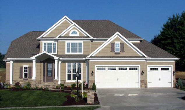 Tanish brown two story home with three car garage and brown shutters and front door.
