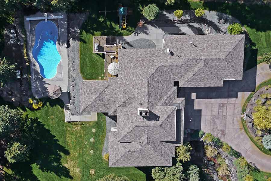 Aerial view of home and yard showing the beautiful high quality roofing materials.