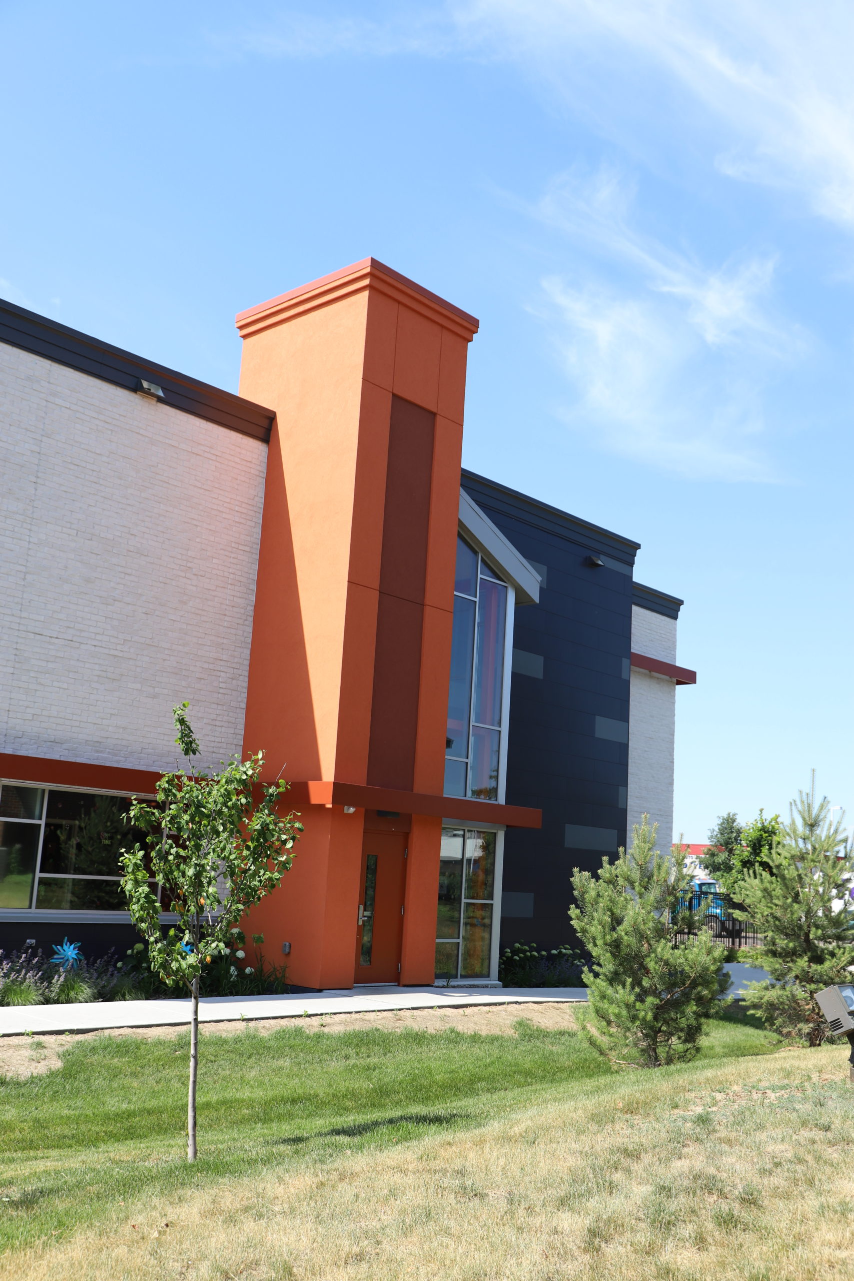 Large commercial building featuring big orange pillar on the side in Apple Valley, MN.