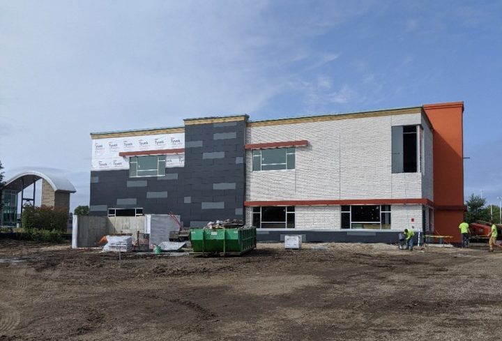 Wide view of large commercial building with Nichiha siding panels being installed in Apple Valley, MN.