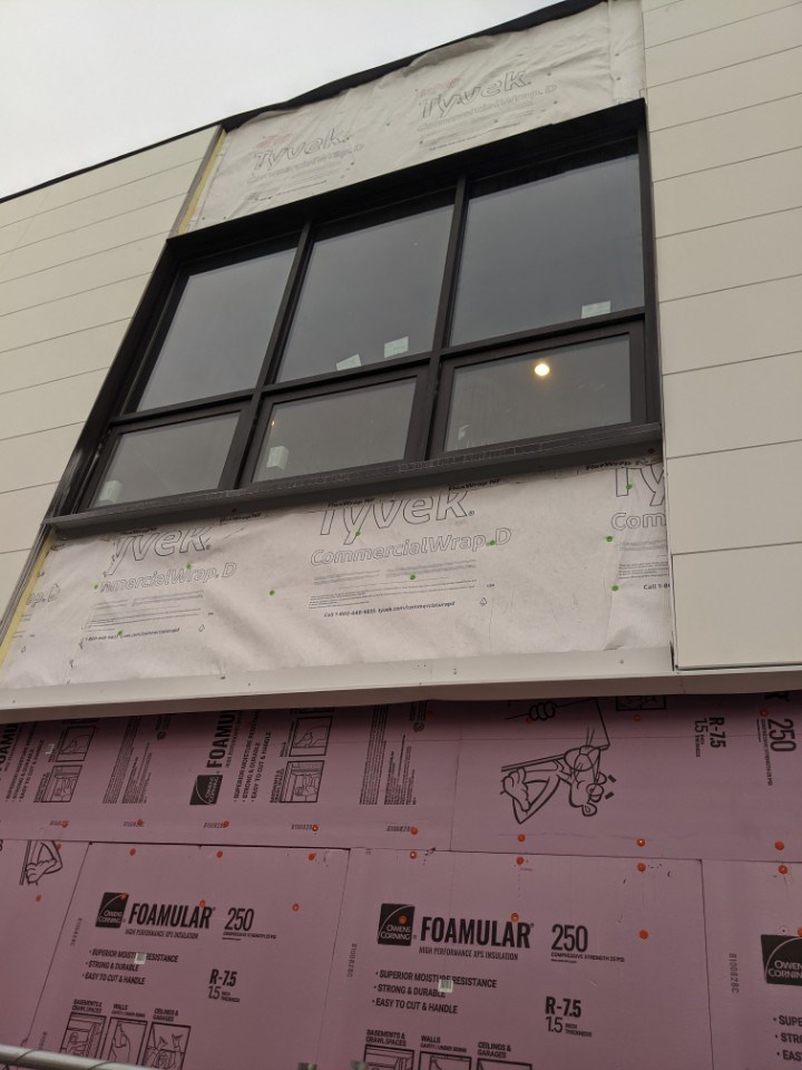 Windows that are ready for siding to be installed around them on the second story of a building in Minneapolis, MN.