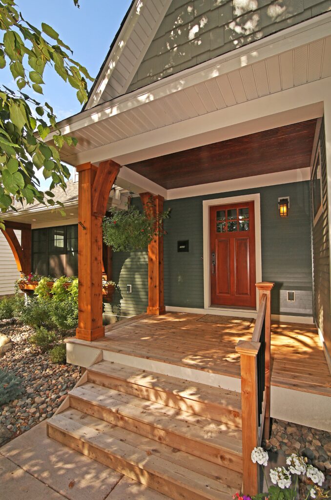 Home styling ideas for a front porch with wooden steps and a wooden door.
