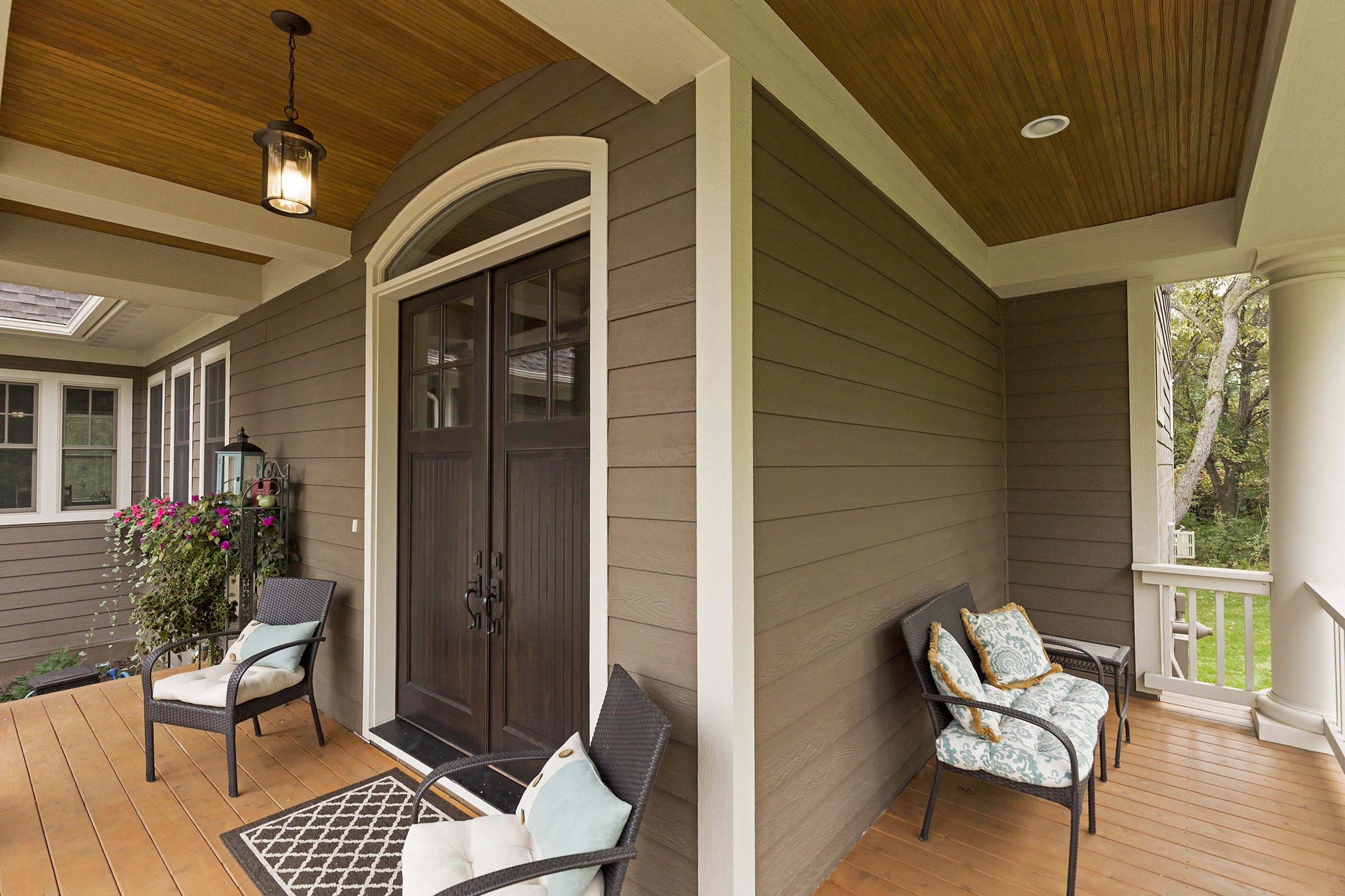 Enhance your home's curb appeal and value with a welcoming front porch featuring a table and chairs.
