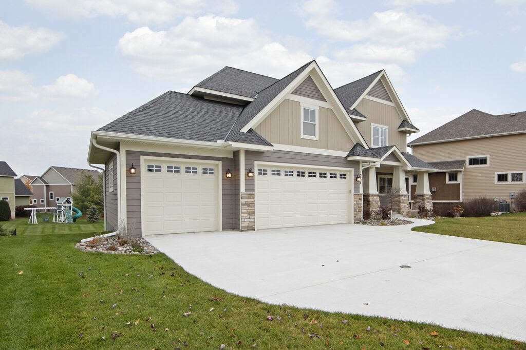 Explore home styling ideas for a spacious residence featuring two garages and a driveway.