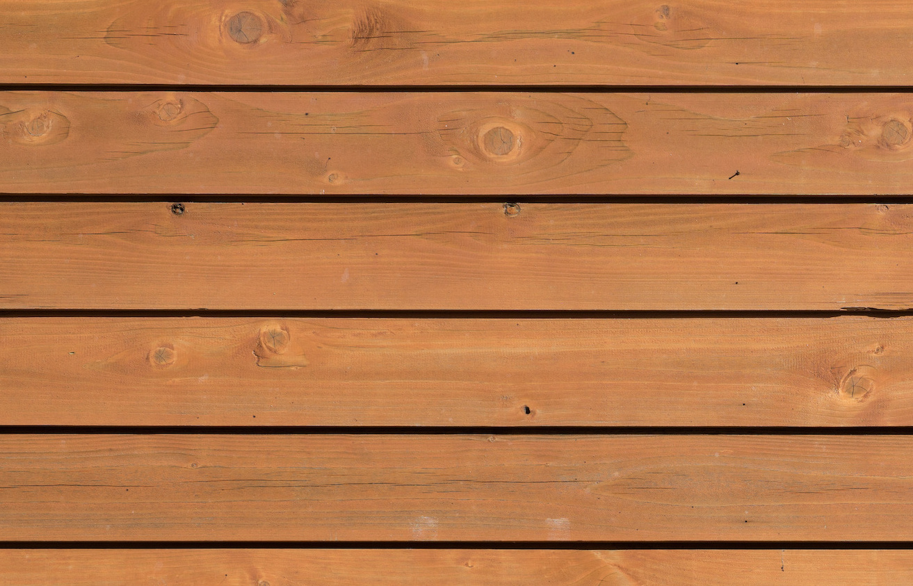 A close up view of a wooden wall, the ultimate home siding guide.