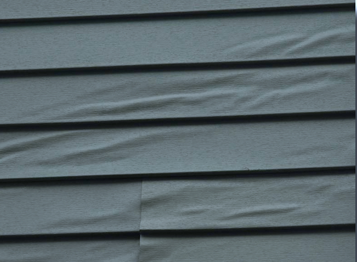 A close up of a gray siding on a house, featured in the ultimate home siding guide.