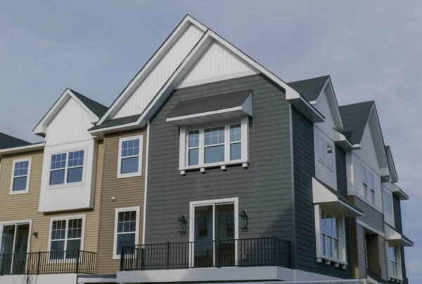 Emery Village Townhomes: A three story townhouse with balconies and a front porch.